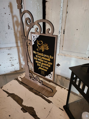 Decorative sign with text on a rustic wooden surface.
